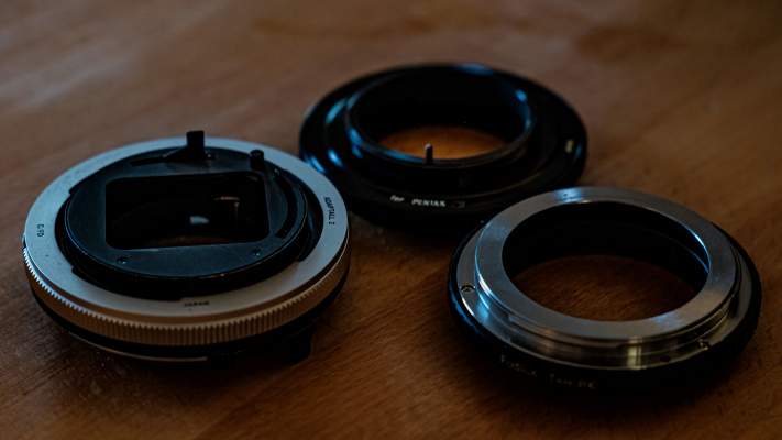 Some of the adapters used to mount the Adaptall 2 lenses to other common mounts. Pictured are mounts for M42, Canon FD and Pentax PK bayonet mounts.